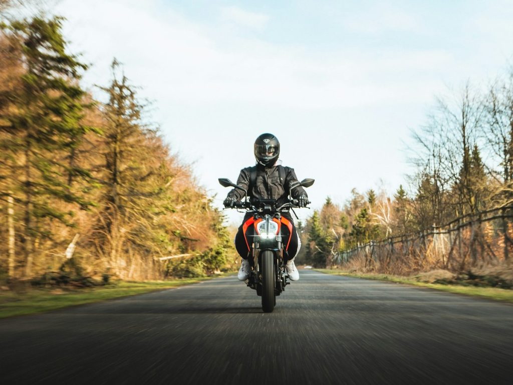 Rider on a street motorcycle approaching on an open road — Basic Rider Course
